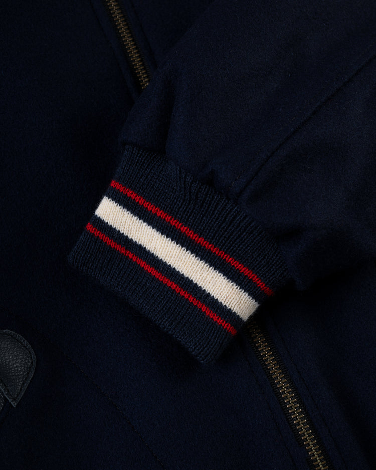 Close-up of the EFF Washington Senators (Nationals) 1951 Authentic All Wool Varsity Jacket sleeve, showing a ribbed navy cuff with white and red stripes, a zipper, and part of a leather patch.