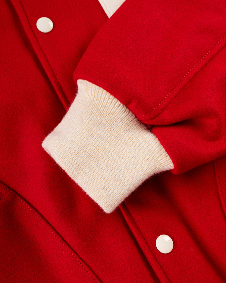 Close-up of the EFF Boston Bees 1939 Authentic All Wool Varsity Jacket sleeve, featuring red wool fabric, a white ribbed cuff, white snap buttons, and detailed stitching.
