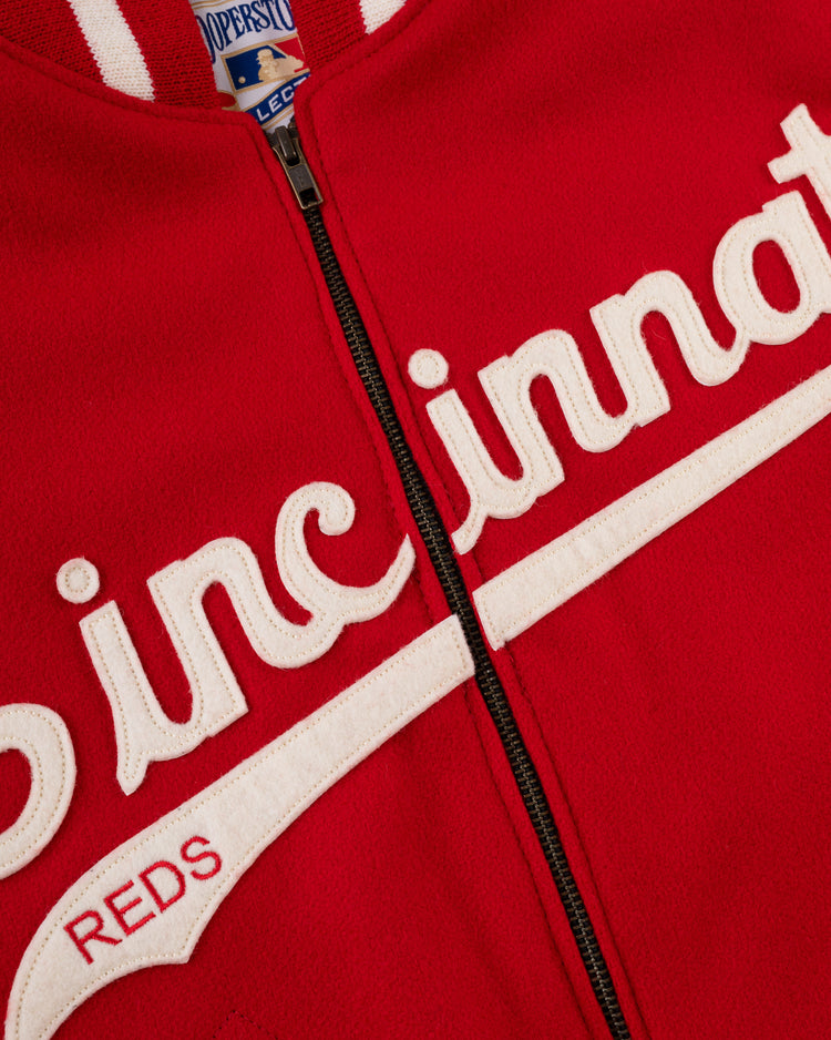 Close-up of an authentic EFF Cincinnati Reds 1969 All Wool Varsity Jacket, featuring white embroidered Cincinnati lettering and a blue Cooperstown Collection tag at the collar, capturing classic team style.