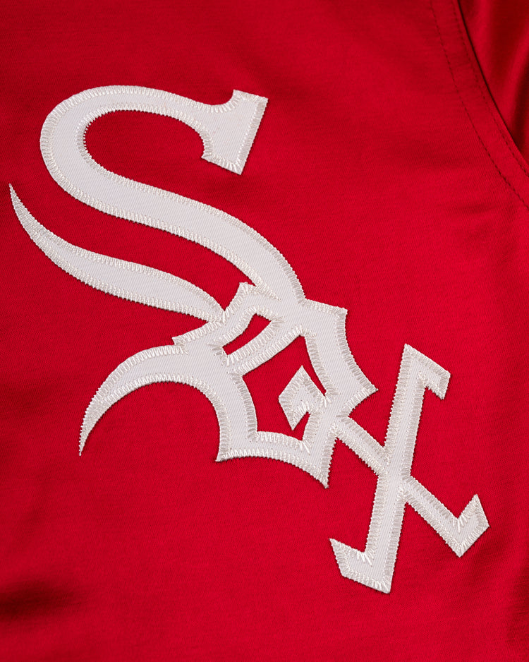 Close-up of the stylized white Sox logo stitched onto bright red fabric on the Chicago White Sox 1971 Satin Windbreaker Jacket by EFF.