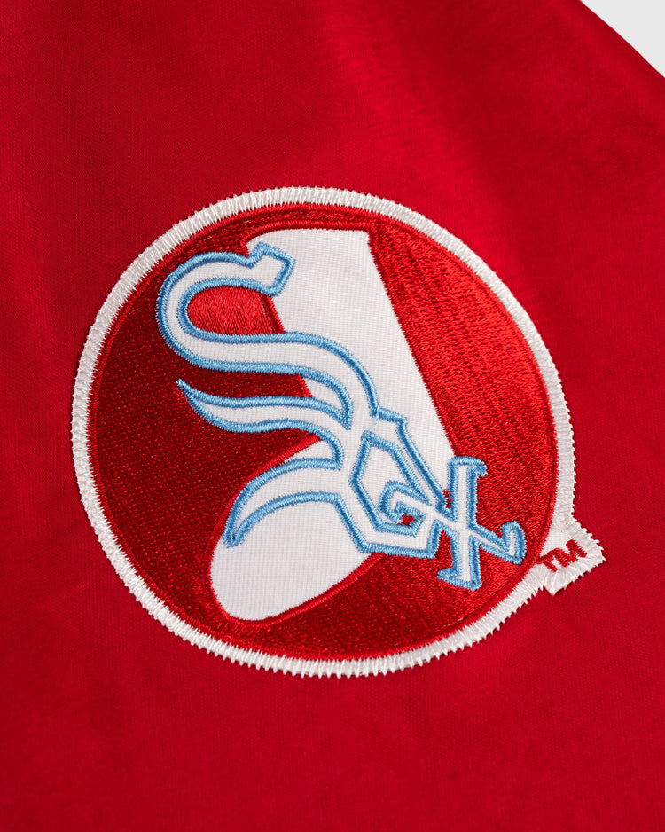 A close-up of a red fabric patch with a white A and Sox in blue and white, inspired by the Chicago White Sox 1971 Satin Windbreaker Jacket by EFF—ideal for MLB vintage fans.