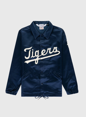 The EFF Detroit Tigers 1960 Satin Windbreaker Jacket is a navy blue jacket with Tigers in large white script, featuring a collar, elastic cuffs, front pockets, and a drawstring hem for classic MLB vintage style.