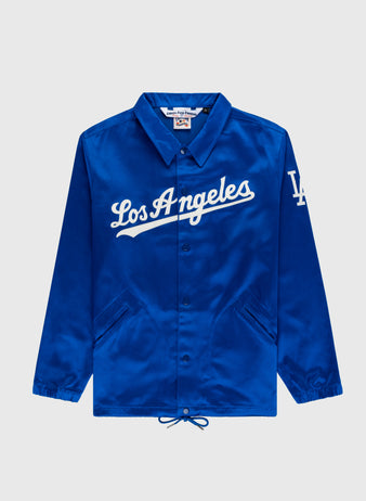 The EFF Los Angeles Dodgers 1962 Satin Windbreaker Jacket features white Los Angeles script, LA logo on the sleeve, buttons, collar, side pockets, and a drawstring hem—perfect for Dodger Stadium.