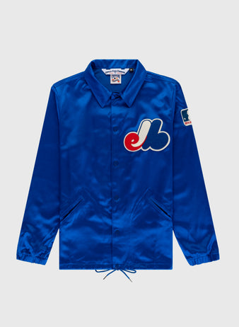 The EFF Montreal Expos 1969 Satin Windbreaker is a royal blue vintage MLB jacket with front pockets, a large Expos logo on the chest, and a patch on the left sleeve, shown against a plain light background.