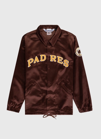 The EFF San Diego Padres 1969 Satin Windbreaker Jacket is a brown authentic MLB style with PADRES in yellow and white, side pockets, elastic cuffs, a collar, snap buttons, and a left-sleeve patch—perfect for vintage baseball fans.
