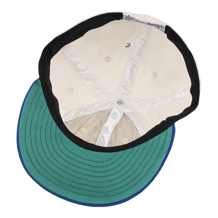 The inside of the EFF University of Kentucky 1968 Vintage Ballcap features a cream crown with white lining, a silver center button, and a green brim underside trimmed in blue.