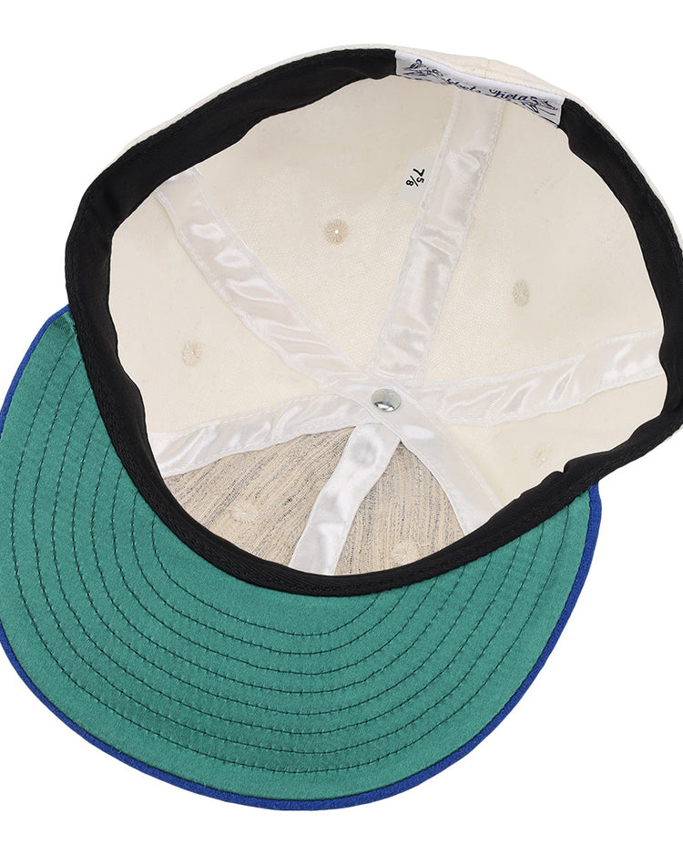 The inside of the EFF University of Kentucky 1968 Vintage Ballcap features a cream crown with white lining, a silver center button, and a green brim underside trimmed in blue.