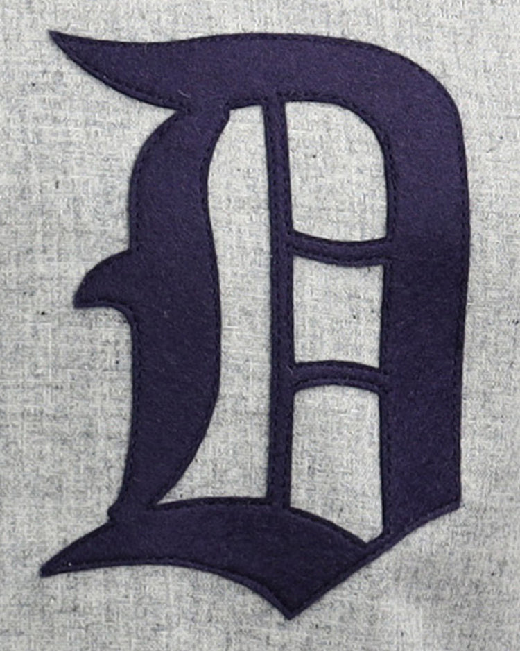 A large, dark blue Old English D is stitched onto light gray fabric on the EFF Duke University 1953 Road Jersey, inspired by a classic College Vault design.