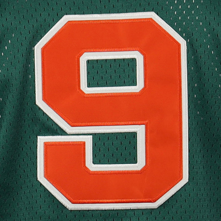 A large orange number 9 with a white outline appears on a dark green mesh button-up jersey from the EFF Carrots Arlington Heights Collection.