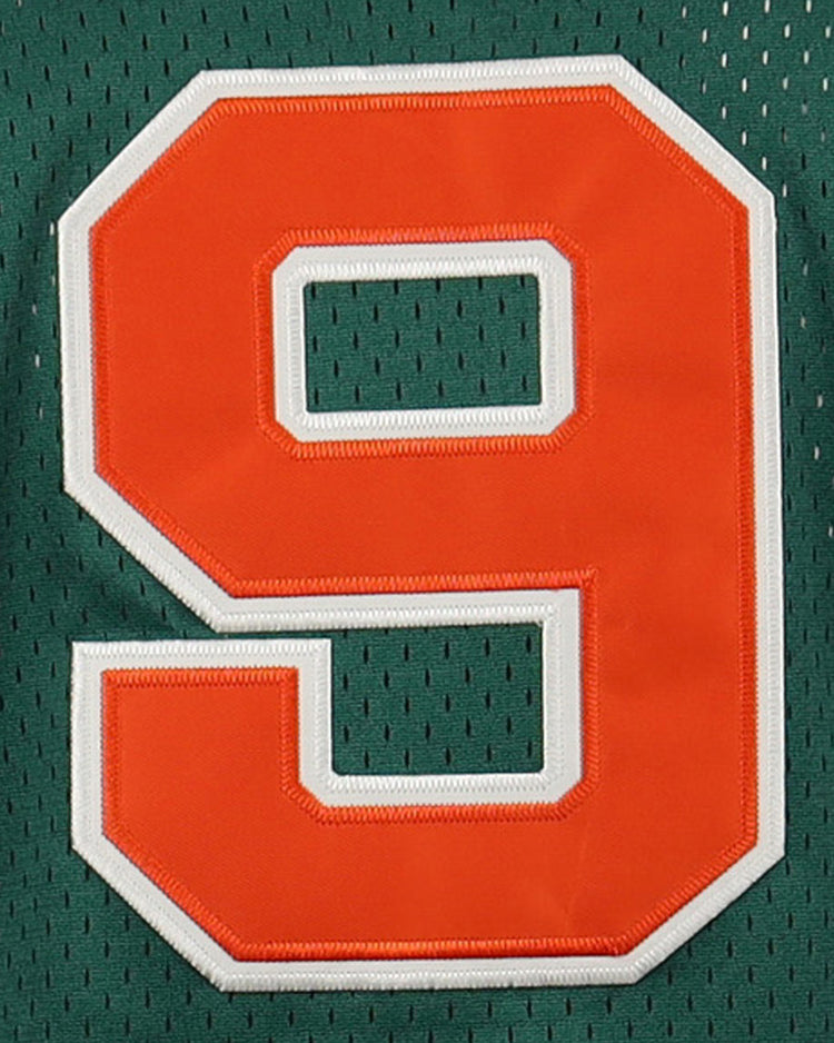 A large orange number 9 with a white outline appears on a dark green mesh button-up jersey from the EFF Carrots Arlington Heights Collection.