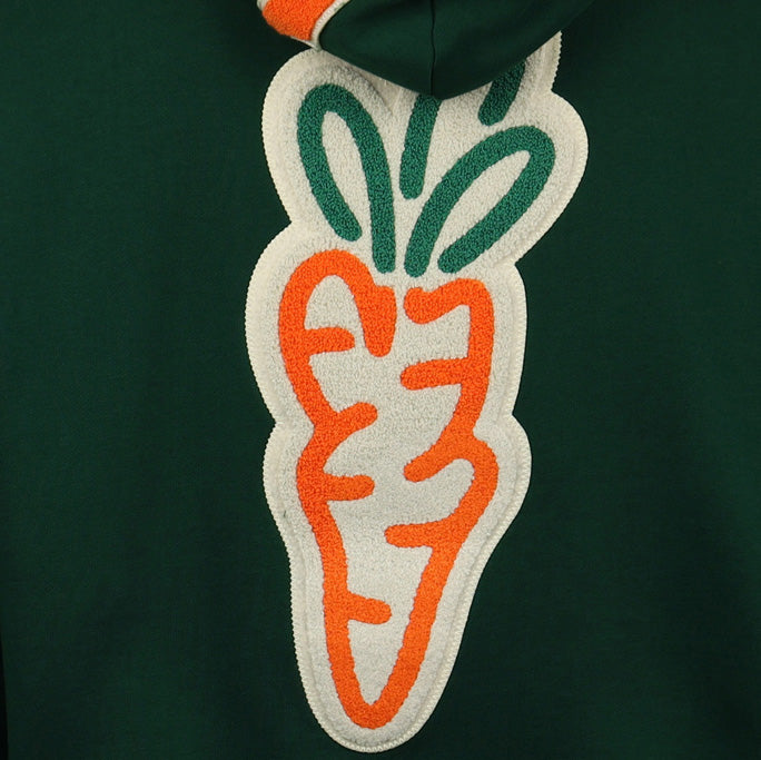 A close-up of the EFF Carrots Arlington Heights Collection Hoodie shows a large, stylized carrot patch with orange, white, and green embroidery on the back, inspired by Arlington Heights Carrots and EFF.