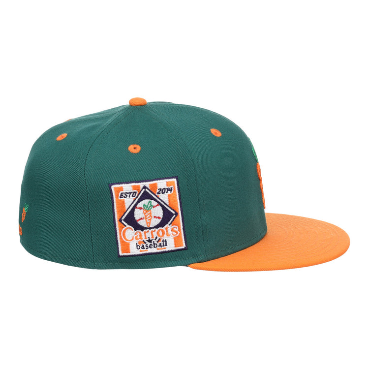 The EFF Carrots Arlington Heights Collection Logo Fitted Ballcap is a green cap with an orange brim and button, featuring a baseball patch with carrot graphic and ESTD 2014, plus a side carrot logo honoring the Arlington Heights Carrots legacy.