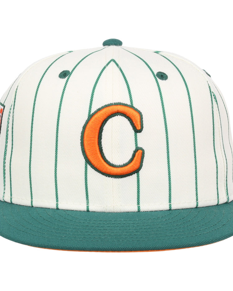 The EFF Carrots Arlington Heights Collection Pinstripe Fitted Ballcap features white fabric with green pinstripes, a green brim, and an orange C outlined in green, made in collaboration with Ebbets Field Flannels.