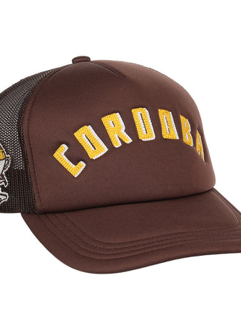 The Cordoba Cafeteros EFF DNA Trucker by EFF is a vintage-inspired brown trucker hat with yellow CORDOBA lettering on the front and an embroidered knight holding a sword on the black mesh side, in classic Ebbets Field Flannels style.