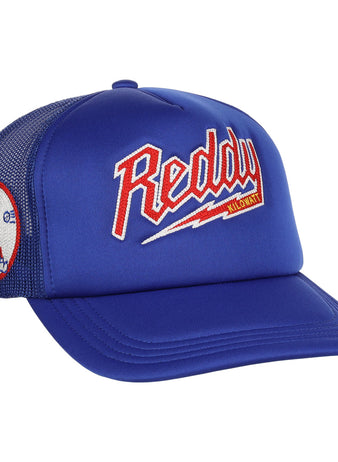 The EFF Reddy Kilowatt EFF DNA Trucker is a blue mesh hat featuring vintage-style chain-stitched red, white, and yellow Reddy Kilowatt embroidery on the front, plus a cartoon Reddy Kilowatt patch on the side.