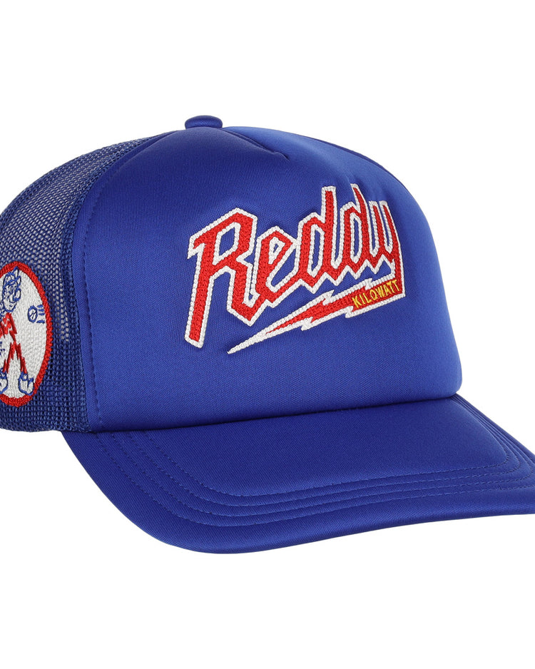 The EFF Reddy Kilowatt EFF DNA Trucker is a blue mesh hat featuring vintage-style chain-stitched red, white, and yellow Reddy Kilowatt embroidery on the front, plus a cartoon Reddy Kilowatt patch on the side.