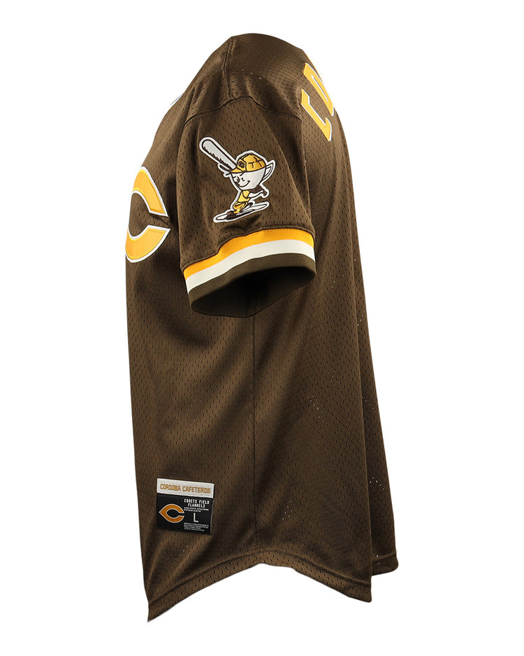 Side view of the Cordoba Cafeteros EFF DNA Replica V-Neck Mesh Jersey by EFF, featuring brown mesh, yellow and white sleeve stripes, cartoon batter patch, large chest “C,” and Cooperstown Collection tag—honoring Mexican baseball history.