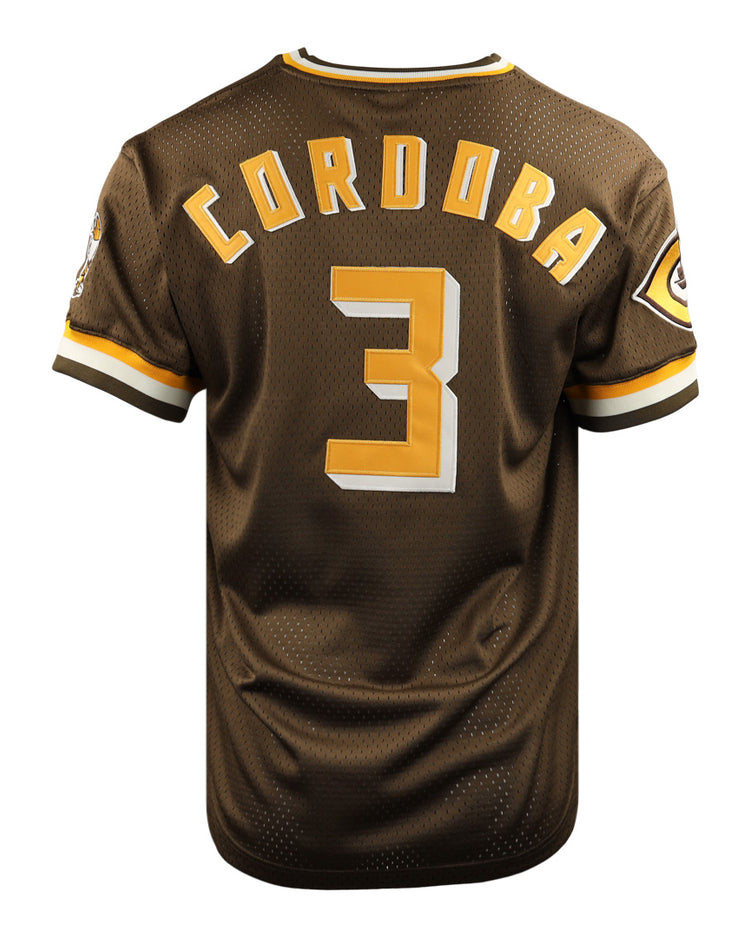 The EFF Cordoba Cafeteros DNA Replica V-Neck Mesh Jersey is a brown baseball jersey with gold and white trim, featuring CORDOBA and the number 3 in gold on the back, plus a Cafeteros legacy patch on the left sleeve, inspired by Mexican pro baseball.