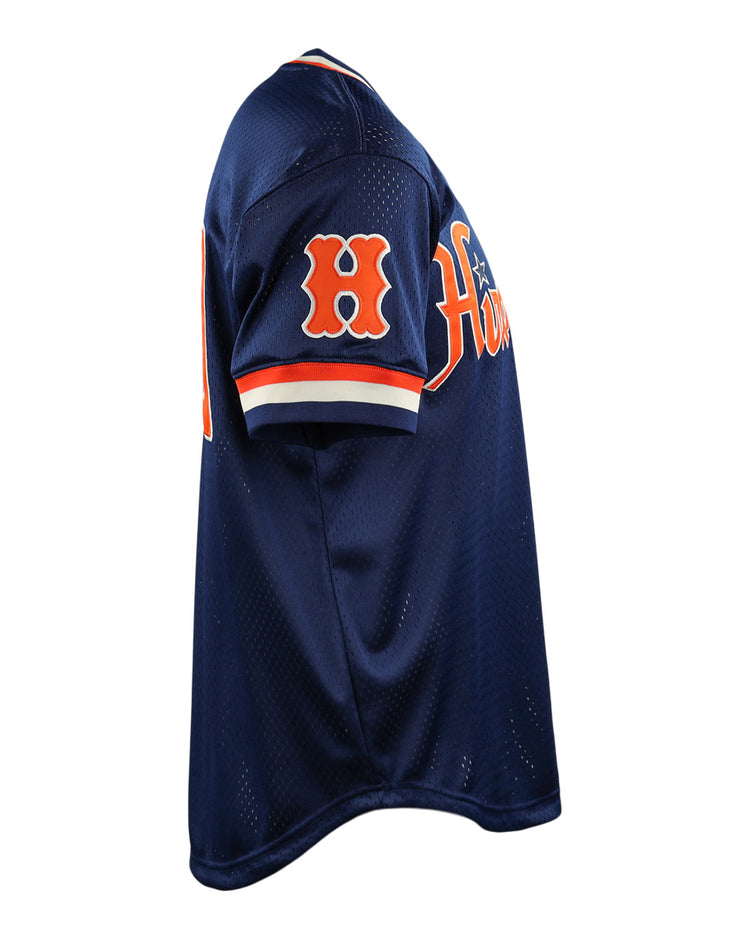 The EFF Hiroshima Carp DNA Replica V-Neck Mesh Jersey is shown from a side angle, featuring navy blue mesh, orange and white sleeve trim, an orange H patch, and partial team text on the chest.