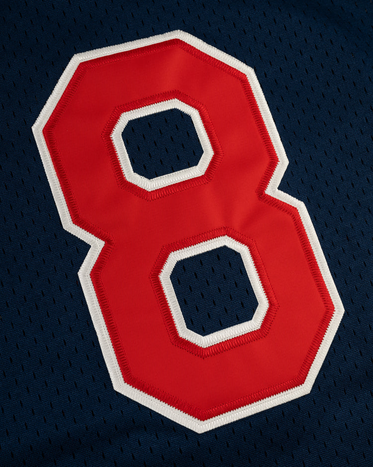A close-up of a red number 8 with a white outline on a dark blue Kansas City Katz Mesh V-Neck Jersey by EFF, evoking classic Ban Johnson Baseball League style.