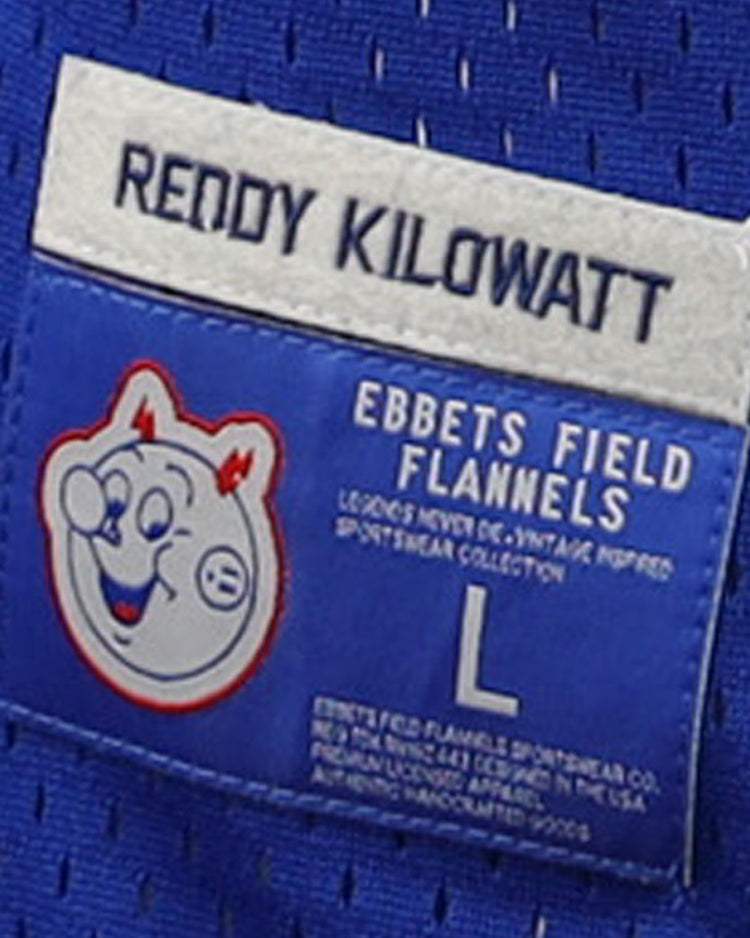 A blue EFF label on the Reddy Kilowatt EFF DNA Replica V-Neck Mesh Jersey features the smiling Reddy Kilowatt cartoon, REDDY KILOWATT text, EBBETS FIELD FLANNELS branding, electric power motif, and size L.