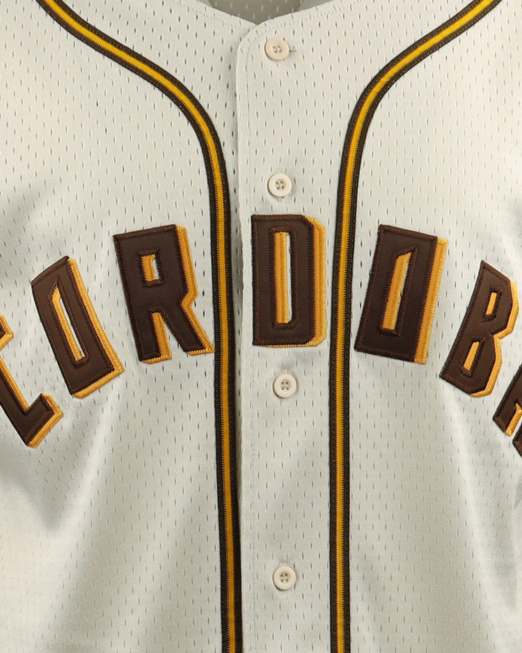 Close-up of the Cordoba Cafeteros EFF DNA Replica Button-Up Mesh Jersey by EFF, a cream baseball jersey with CORDOBA in bold brown and yellow letters on the chest and black-and-yellow piping along the buttons.