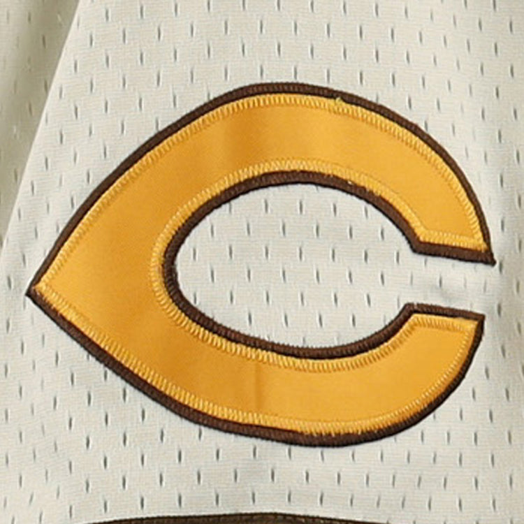 A yellow letter C with a brown outline is sewn onto a light mesh fabric, featured on the Cordoba Cafeteros EFF DNA Replica Button-Up Mesh Jersey by EFF, celebrating Mexican baseball heritage.