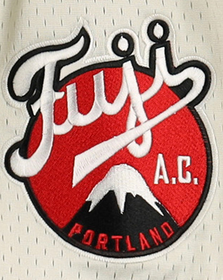A circular patch on the Fuji Athletic Club EFF DNA Replica Button-Up Mesh Jersey by EFF shows stylized Fujis A.C. over red, with a white mountain and Portland at the bottom—honoring Portland Fuji and Japanese baseball heritage.