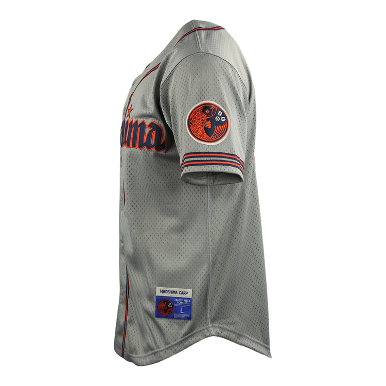 A gray Hiroshima Carp EFF DNA Replica Button-Up Mesh Jersey by EFF, inspired by vintage mesh jerseys, features red and navy accents, a circular patch on the sleeve, partial California text on the chest, and a stitched team/size label above the hem.