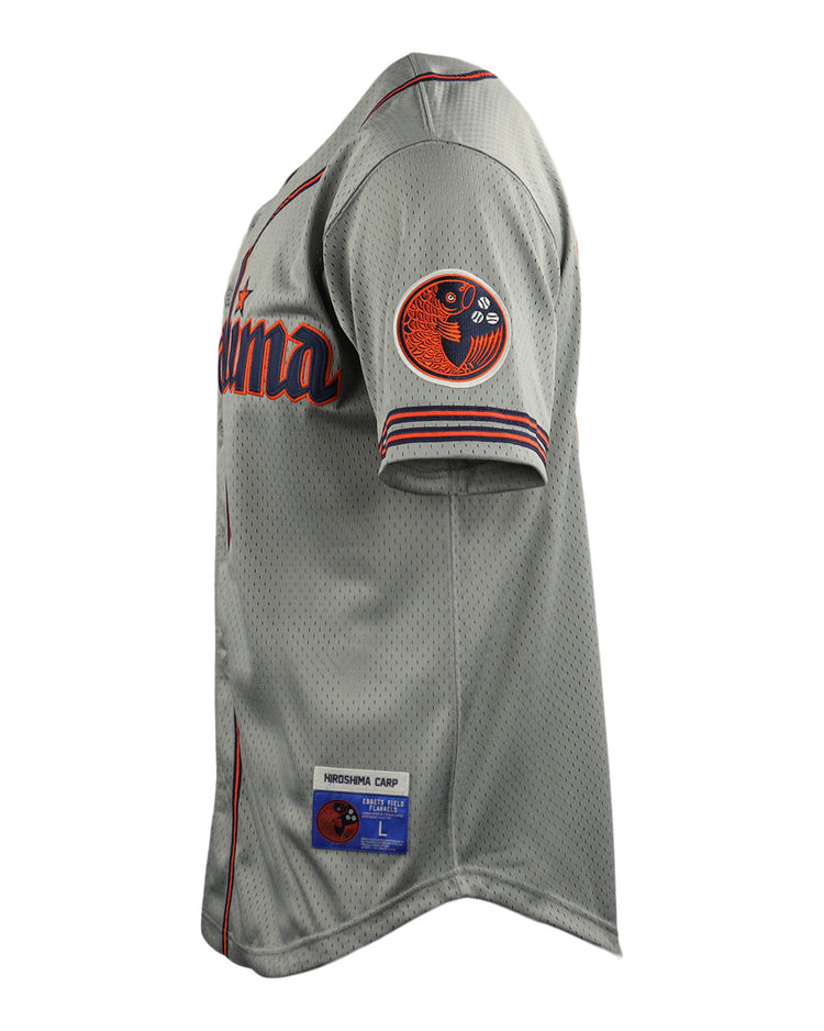 A gray Hiroshima Carp EFF DNA Replica Button-Up Mesh Jersey by EFF, inspired by vintage mesh jerseys, features red and navy accents, a circular patch on the sleeve, partial California text on the chest, and a stitched team/size label above the hem.