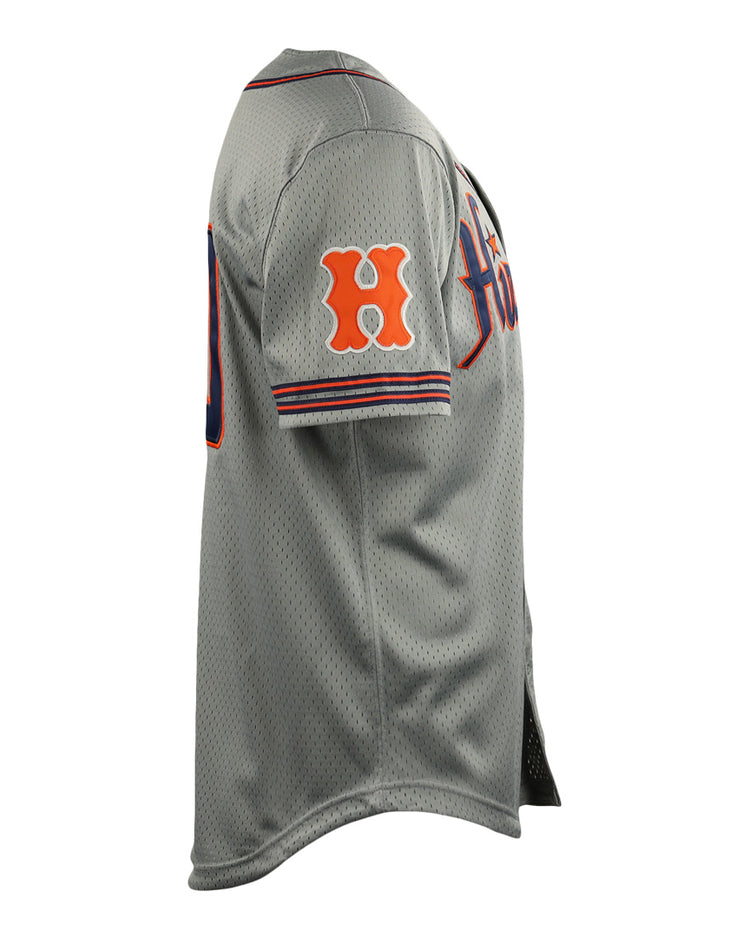 Side view of the Hiroshima Carp EFF DNA Replica Button-Up Mesh Jersey by EFF, a gray vintage mesh jersey with orange and navy accents, an orange H on the sleeve, and partially visible front text inspired by classic Ebbets Field Flannels designs.