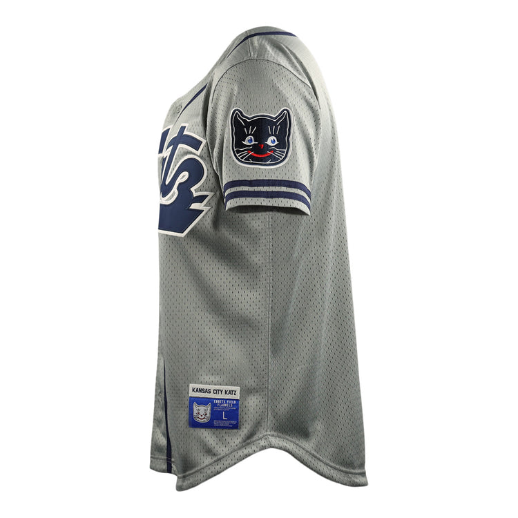 The Kansas City Katz EFF DNA Replica Button-Up Mesh Jersey by EFF features gray mesh fabric, navy and white sleeve trim, a black cat shoulder patch, and a Kansas City Katz label near the hem—honoring the iconic Katz Drugstore legacy.