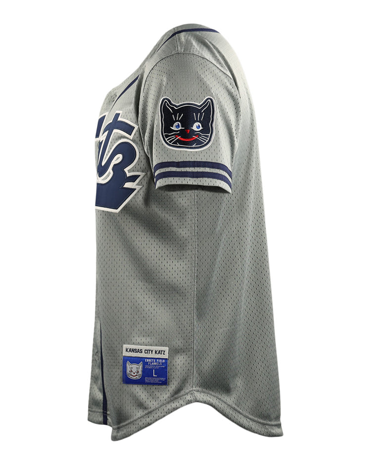 The Kansas City Katz EFF DNA Replica Button-Up Mesh Jersey by EFF features gray mesh fabric, navy and white sleeve trim, a black cat shoulder patch, and a Kansas City Katz label near the hem—honoring the iconic Katz Drugstore legacy.