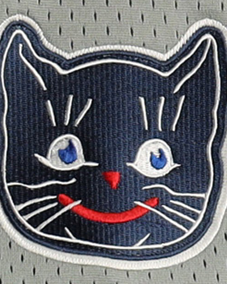 The Kansas City Katz EFF DNA Replica Button-Up Mesh Jersey by EFF features a smiling cat face with blue eyes, red nose and mouth on a gray perforated background, inspired by the iconic Katz Drugstore mascot. The cats face is outlined in white thread.