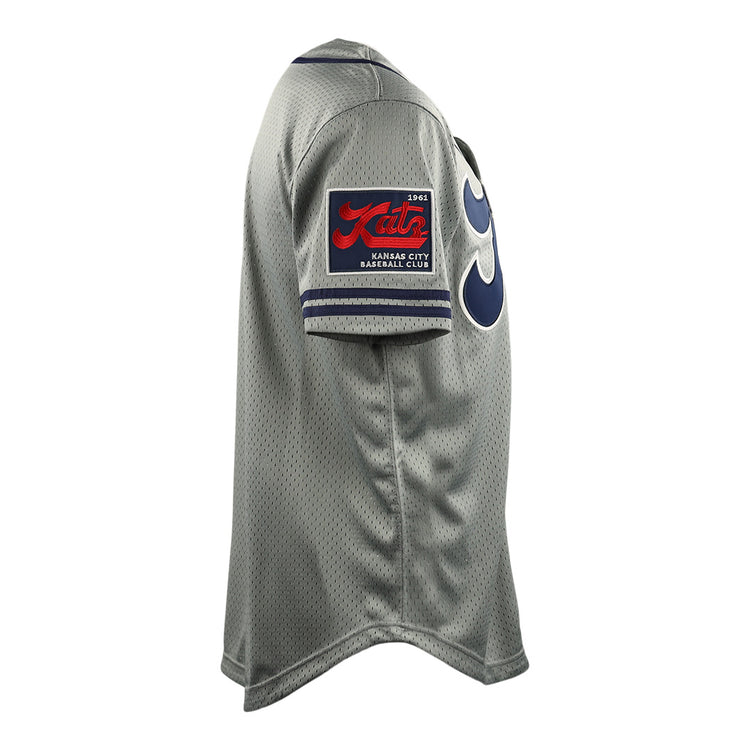 Side view of the Kansas City Katz EFF DNA Replica Button-Up Mesh Jersey by EFF, featuring a gray design, red and black patch on the sleeve, bold blue numbers on the front, and honoring the Ban Johnson Baseball League.