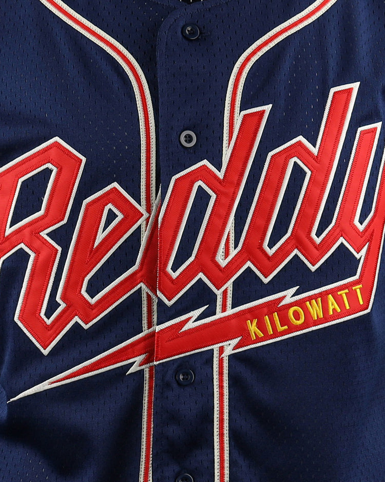 The EFF Reddy Kilowatt EFF DNA Replica Button-Up Mesh Jersey is a navy blue baseball jersey featuring Reddy Kilowatt in bold red script outlined in white, plus Kilowatt in yellow on a red lightning bolt—celebrating electric power.