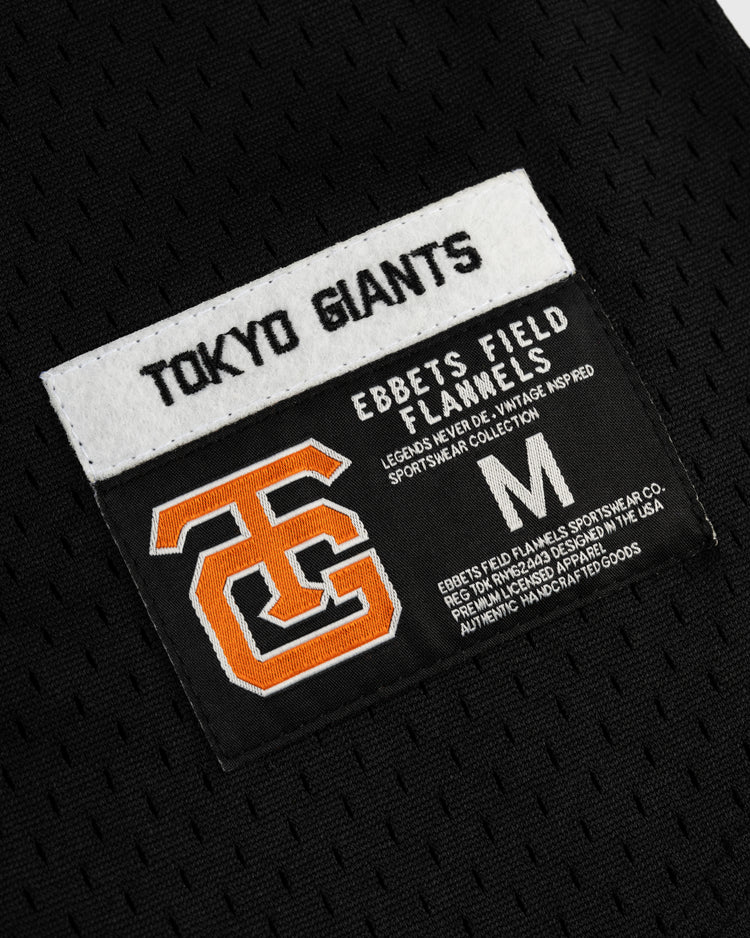 Close-up of a black fabric patch on the EFF Tokyo Giants Mesh Button-Up Jersey, featuring vintage-inspired TOKYO GIANTS text, an orange interlocking TG logo, and classic sportswear details with size M.
