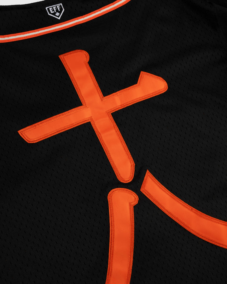 Close-up of the EFF Tokyo Giants Mesh Button-Up Jersey featuring bold orange letters, a black mesh design, thin orange and white collar trim, and an EFF label—details inspired by vintage Tokyo Giants style.