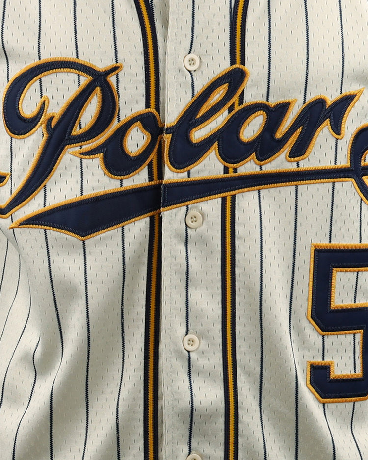 A close-up of the EFF Cerveceria Polar EFF DNA Replica Button-Up Mesh Jersey, featuring white pinstripes, Polar in script across the chest inspired by Cuban League amateur baseball, and a blue and gold number 5 on the lower right.