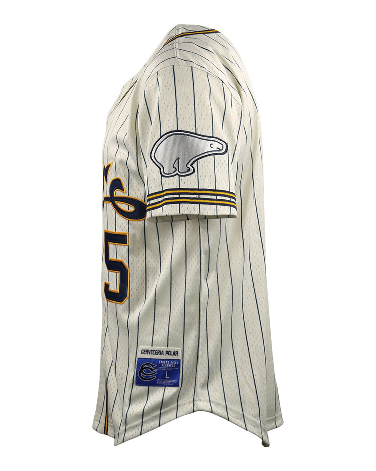 The EFF Cerveceria Polar DNA Replica Button-Up Mesh Jersey is a white, pinstriped baseball shirt with navy and yellow details, the number 25, a bear patch on the sleeve, and classic style shown in side view.