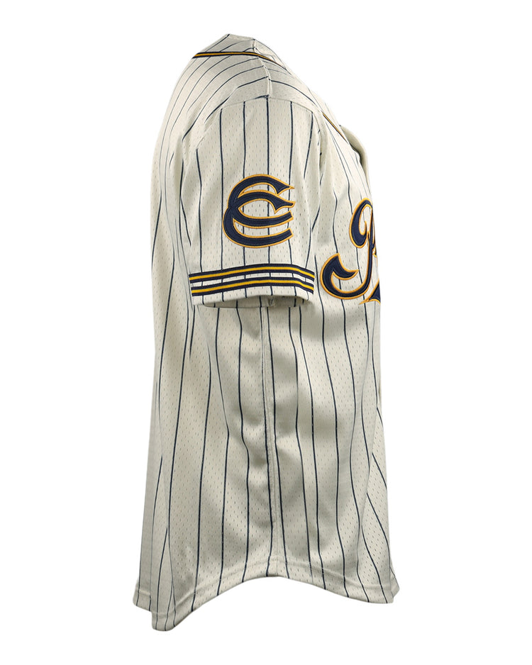The EFF Cerveceria Polar DNA Replica Button-Up Mesh Jersey features a cream color, short sleeves, thin navy stripes, sleeve patches, and yellow trim inspired by classic Cuban League baseball uniforms—shown from a side view.