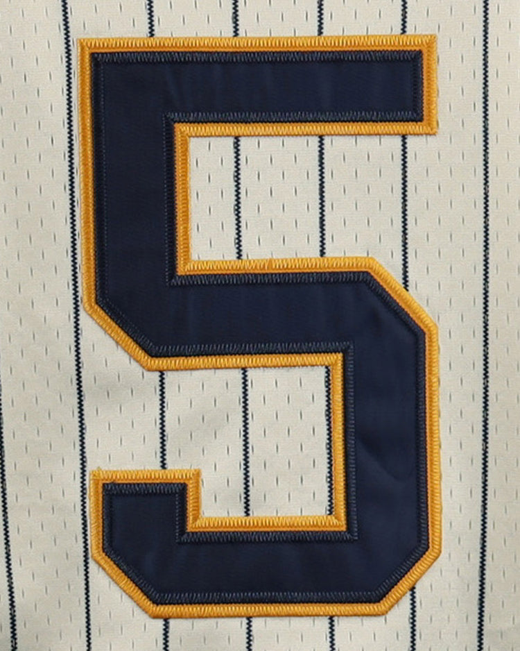 A close-up of the EFF Cerveceria Polar DNA Replica Button-Up Mesh Jersey, showcasing pinstripes and a bold navy number 5 accented with gold stitching.