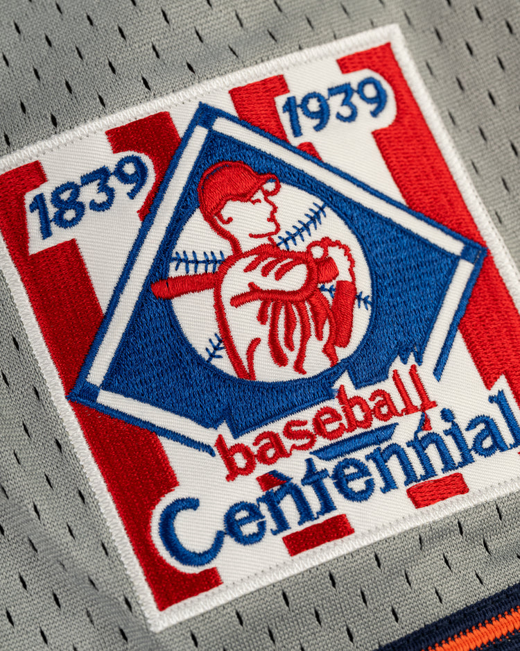 The EFF New York Knights Mesh Button-Up Baseball Jersey features red, white, and blue colors with 1839 1939 Baseball Centennial and a vintage player illustration with bat and baseball stitches in the background.