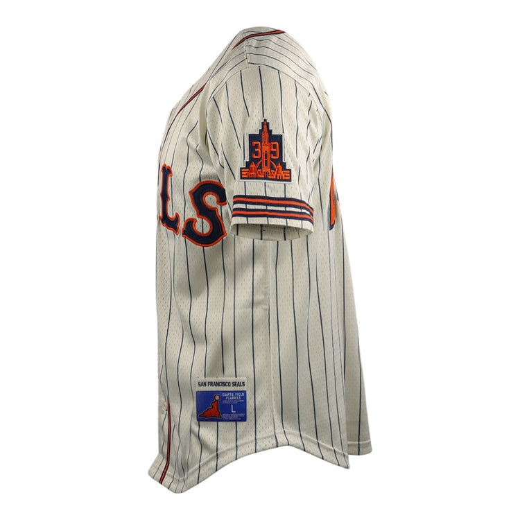 The San Francisco Seals EFF DNA Replica Button-Up Mesh Jersey by EFF is cream-colored with blue pinstripes, red and blue SEALS lettering, plus EFF patches on the sleeve and hem—honoring the legacy of the San Francisco Seals.