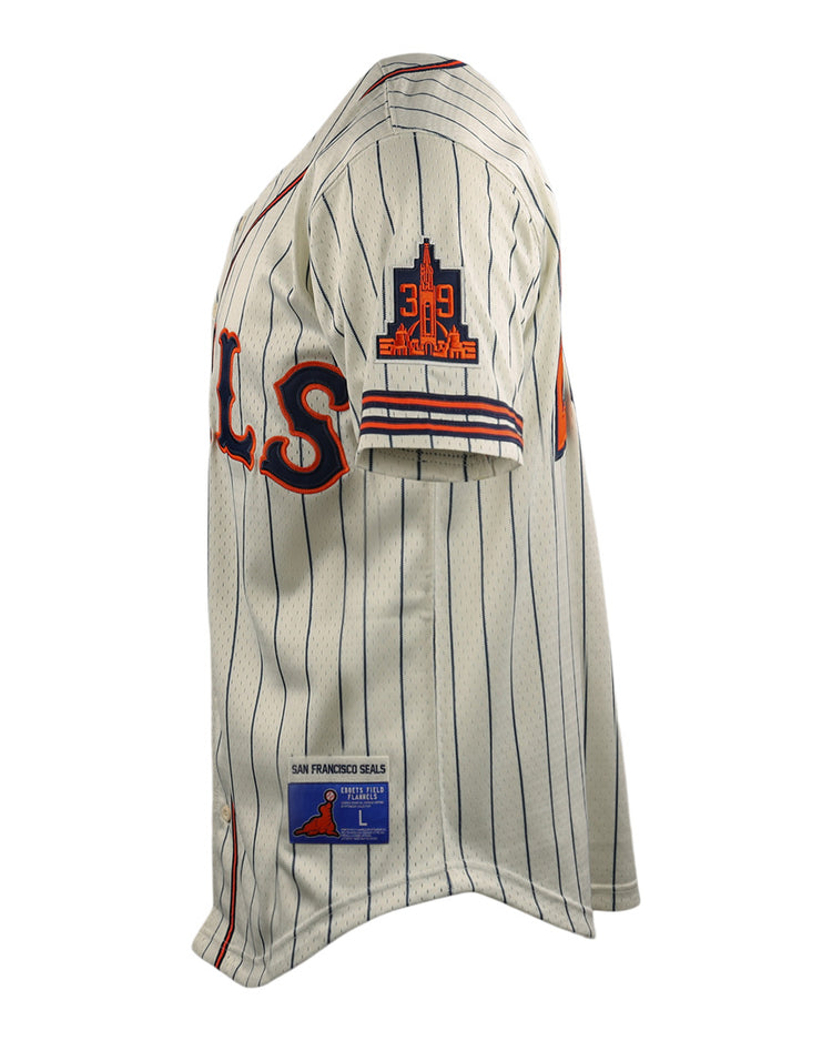 The San Francisco Seals EFF DNA Replica Button-Up Mesh Jersey by EFF is cream-colored with blue pinstripes, red and blue SEALS lettering, plus EFF patches on the sleeve and hem—honoring the legacy of the San Francisco Seals.