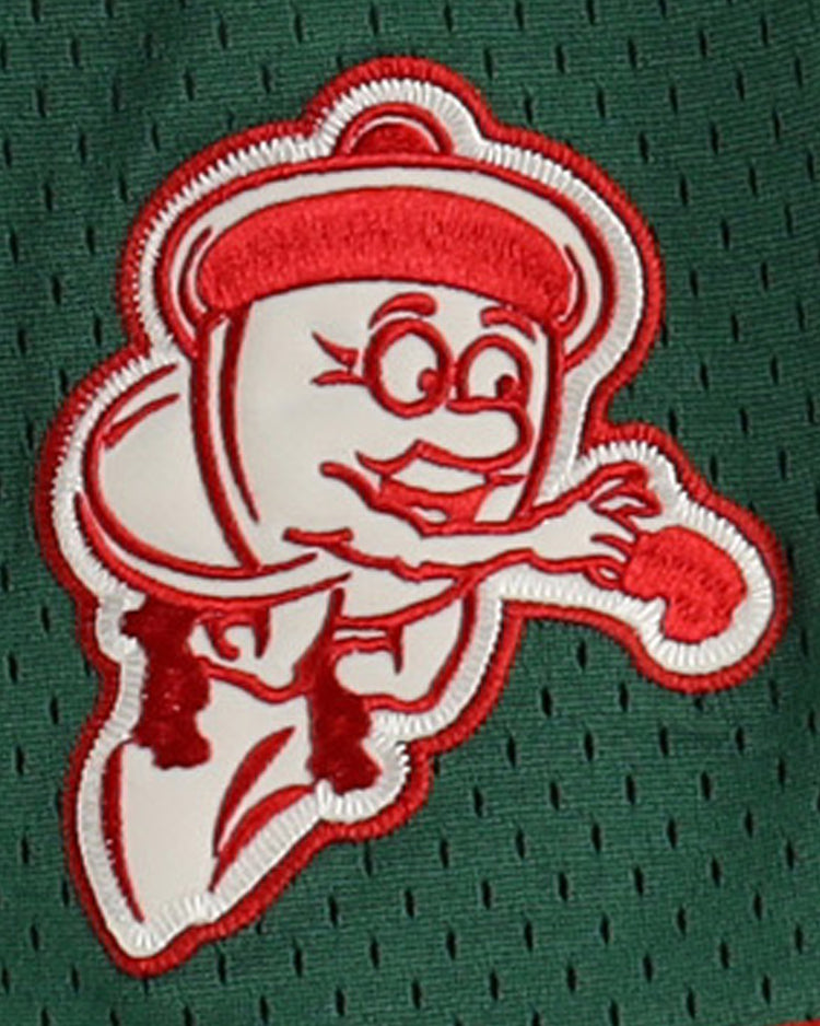 A cartoonish ketchup bottle mascot with arms, legs, and glasses, reaching forward in red on green mesh, decorates the Oakland Oaks EFF DNA Replica Button-Up Mesh Jersey by EFF.