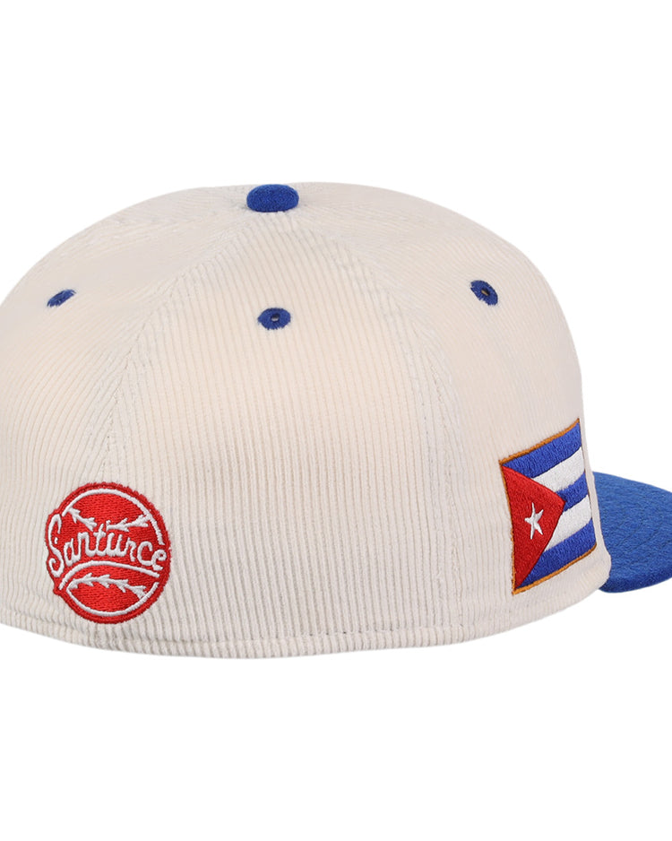 The EFF Santurce Cangrejeros NLB Ground Rule Double Fitted Ballcap is a white corduroy vintage-style hat with blue accents, featuring a red Santurce patch and Cuban flag patch, honoring Puerto Rican League heritage.