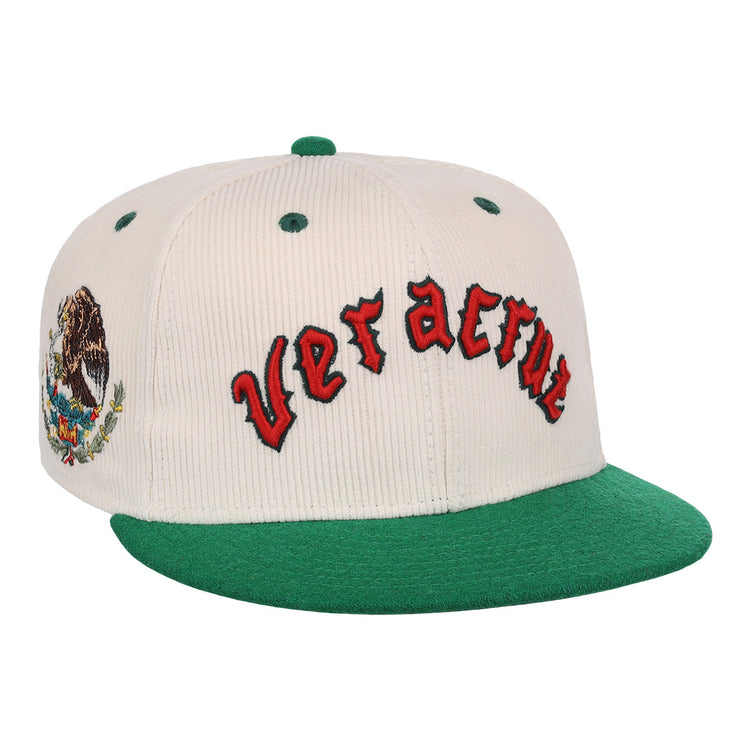 The EFF Veracruz Azules NLB Ground Rule Double Fitted Ballcap features white and green panels, Veracruz in red on the front, and the Mexican national emblem on the side—a classic for true fans.