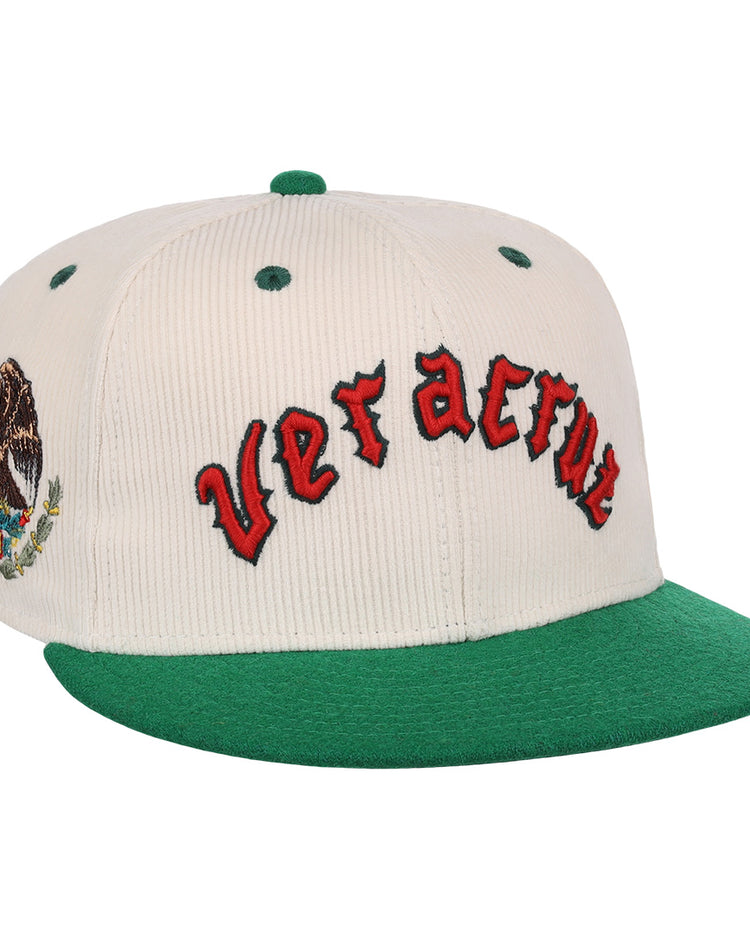 The EFF Veracruz Azules NLB Ground Rule Double Fitted Ballcap features white and green panels, Veracruz in red on the front, and the Mexican national emblem on the side—a classic for true fans.