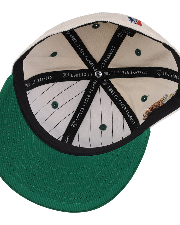 The underside of the Veracruz Azules NLB Ground Rule Double Fitted Ballcap by EFF features a green brim, black sweatband with EBBETS FIELD FLANNELS text, and a white crown with green pinstripes and ventilation holes.